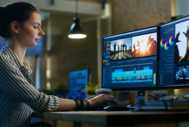A woman editing videos on the computer.